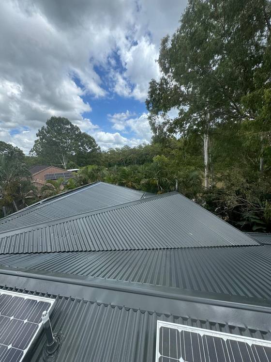 A grey metal roof with solar panels