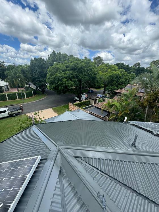 A charcoal metal roof after a full recoat