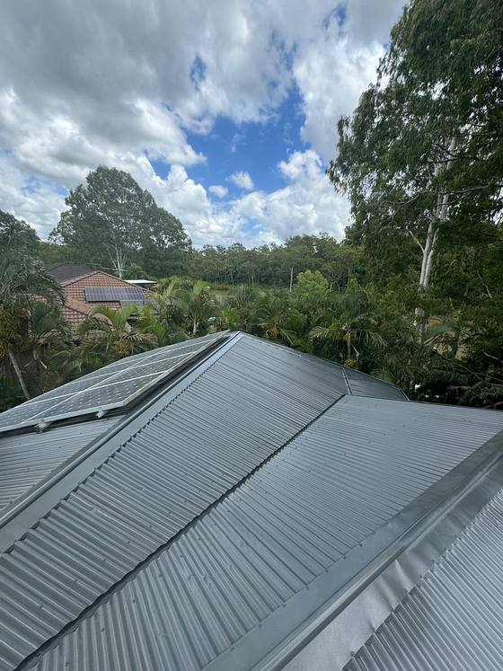 A wide grey metal roof, freshly coated
