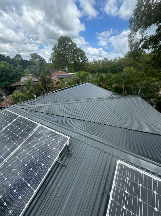 A grey roof with solar, cleaned and recoated