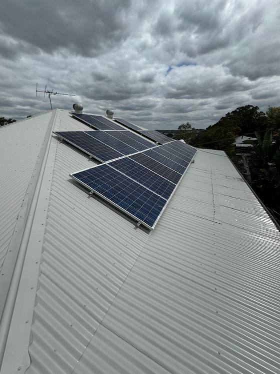 A white metal roof with solar panels