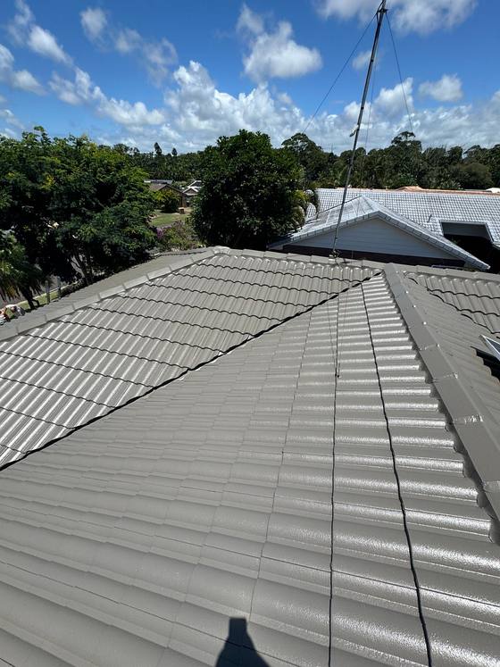 A charcoal tile roof after recoating